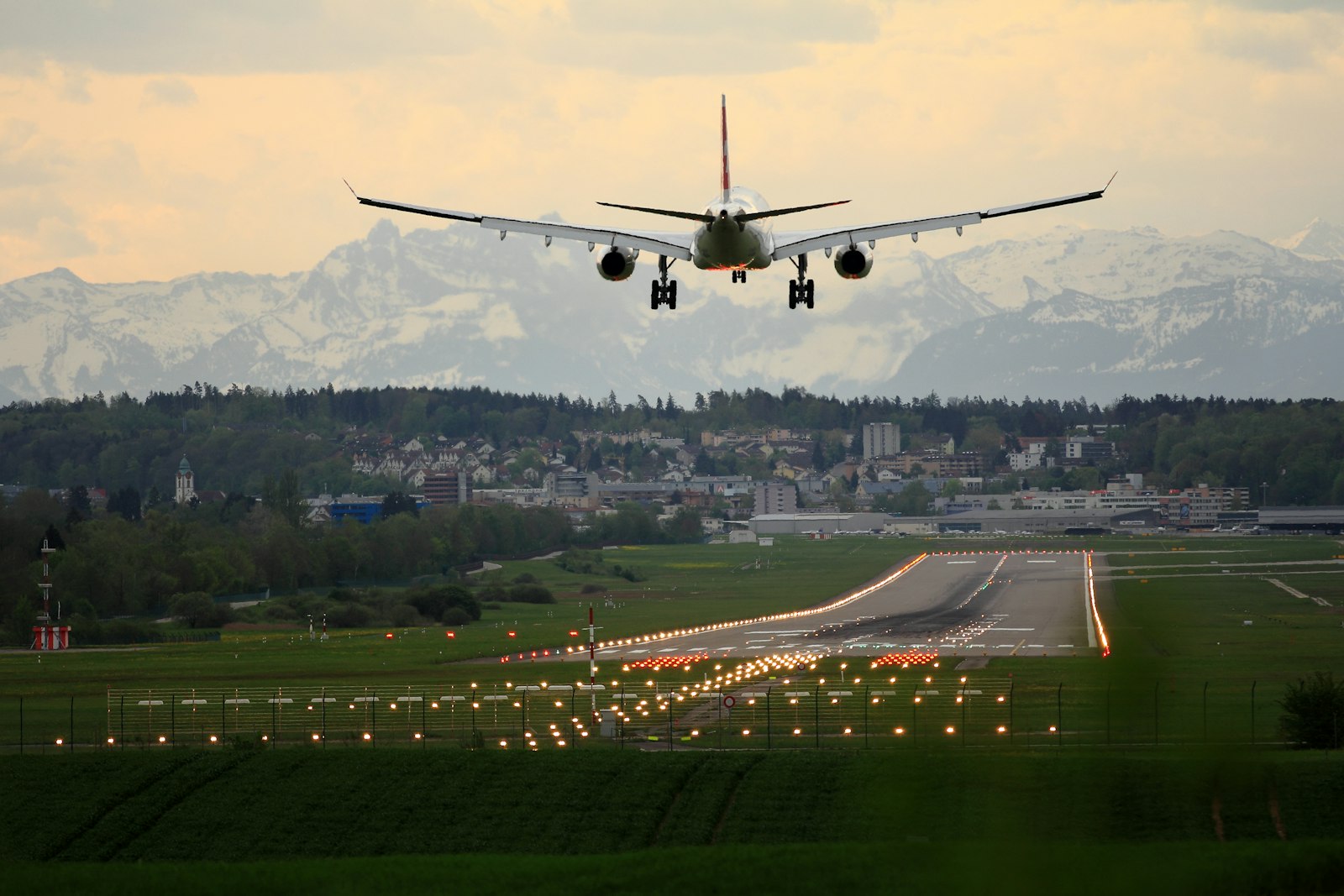 Aircraft on approach to a runway with mountains behind