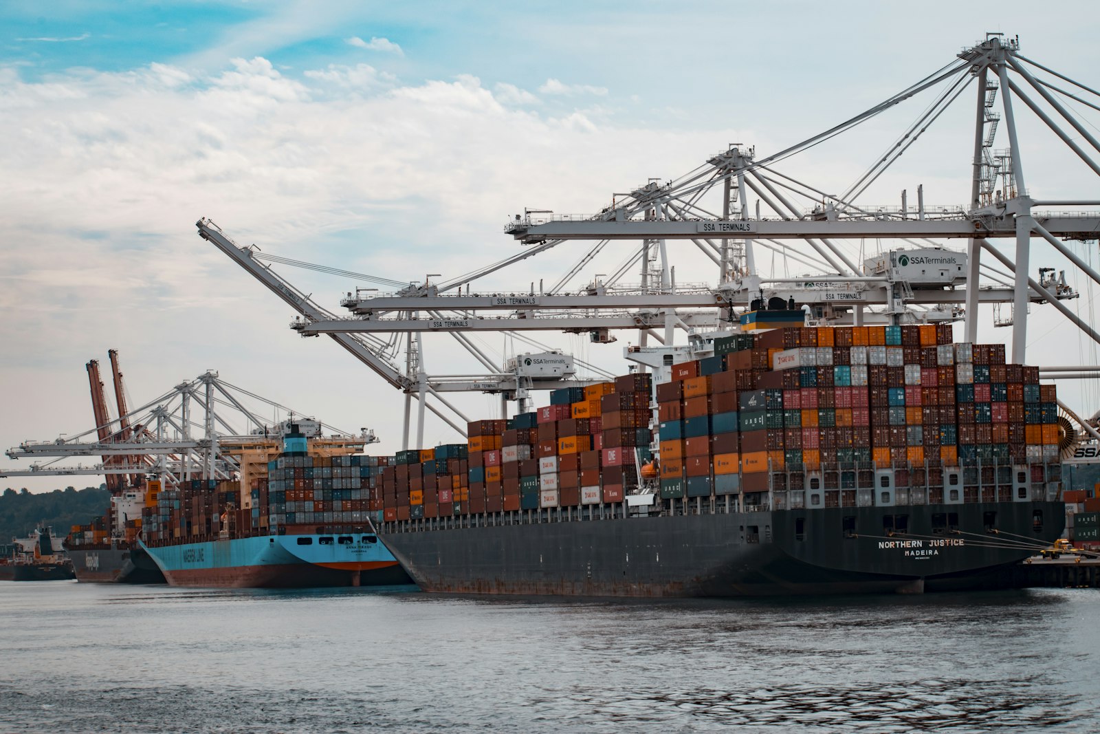 Container ship alongside cranes at a port